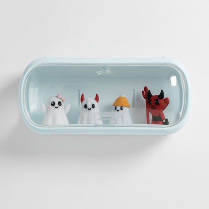 Small figurines of a ghost, a cat, a turtle, and a devil inside a clear blue container on a white background.